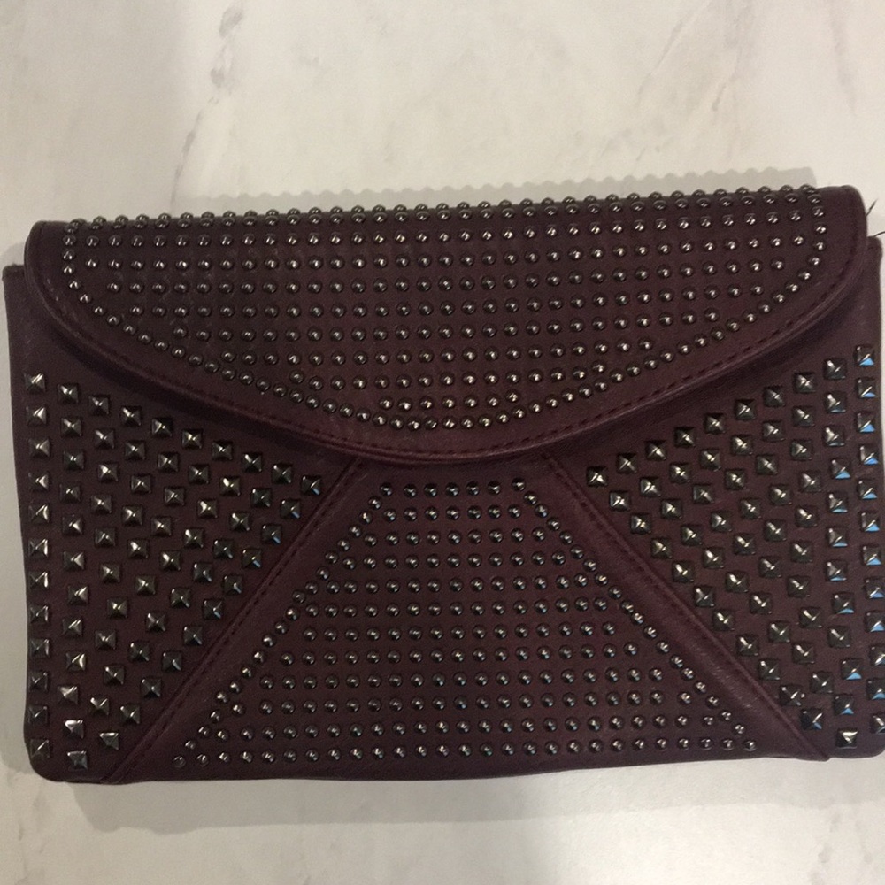 Studded clutch with attachable shoulder strap